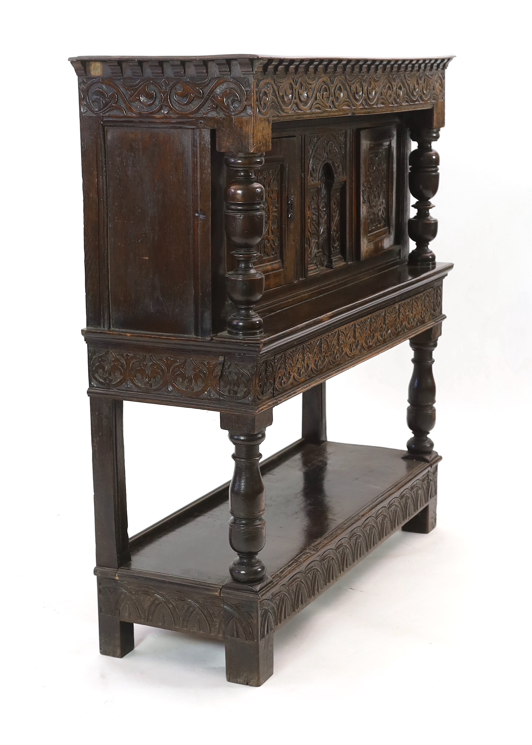 A Charles I carved oak court cupboard